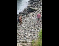 Man buffed shirtless strong pose beach pictorial