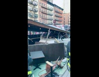white car under rubble of collapsed outdoor structure