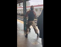 Guy dance at the train station hold heavy thing 