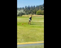 Woman playing golf hits ball goes to other direction