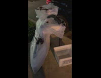 Bike wrapped in plastic bubble wrap on the sidewalk