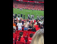 Man with wound on face at football audience