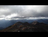 Time lapse view of mountains below clouds