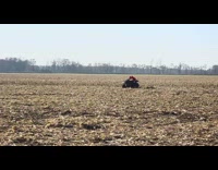 a kid in red rides a four wheeler on an open field and flips forward