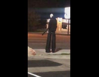 Slenderman costume sidewalk night time