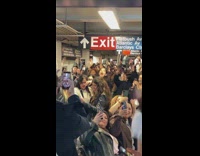 Crowd sings bad bunny song waiting for subway
