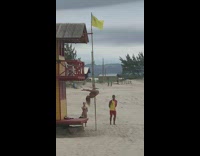 Woman bikini climb pose on pole beach