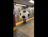 Man wearing inflatable soccer ball costume 