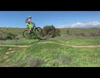 man bright green pants crashes bike