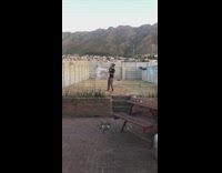 Man gets laundry on a windy day 