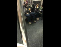 Guy rides subway pet lizard black jacket