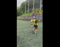 Woman doing dribbling tricks with football for a crowd of young women