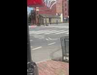 Guy plays flute instrument on round block 