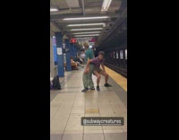 Two guys dance lift each other subway station