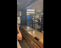 People climbs railings and crosses flooded subway
