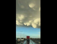 Guy in car sees large white cloud 