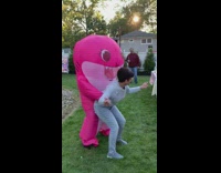 Pink baby shark costume dances with lady