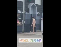 Collab Kook Of The Day - guy in tiger print speedo shirtless standing in front of store