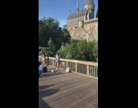 Woman white shirt Gryffindor scarf Hogwarts castle