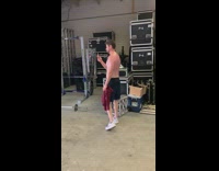 Shirtless guy beard lift dumbbell many camera