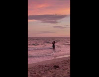 Woman black dress take selfies beach sunset