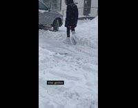 Girl walks with bags over shoes snowstorm 