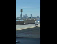 Guy in green dances near water 