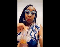 Lady uses glasses straw to drink beer 