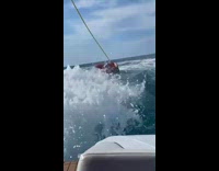 Two people on inflatable raft fall off 