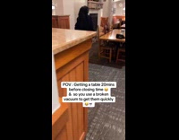 Restaurant employee signaling customers about closing time 