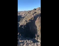 Guy jumps as geyser water shoots up