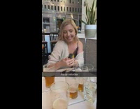 Brown shirt girl bird sits hand restaurant 