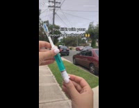 Girl fills portable toothbrush with toothpaste 