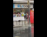 Man music video shoot rain raincoat