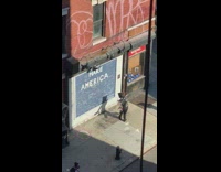 Guy mirrors on shoulders arms dances sidewalk 