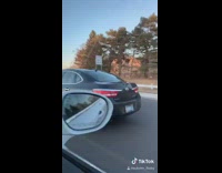 Girl driving car rolls eyes back waves