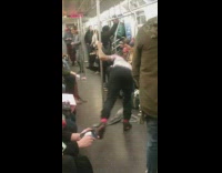 Guy dances swings around metal pole subway