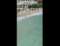 Guy sits gets knocked back ocean wave