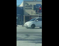 Woman poses outside hair salon 
