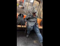 Sleeping man on subway wearing tinfoil headdress