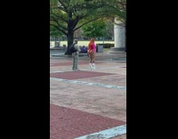 Woman in pink outfit shakes body and butt at the park