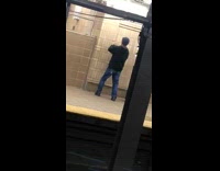 man punching air facing wall