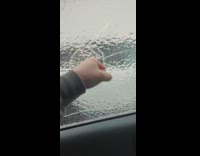Formed ice on the car window gets punched