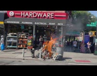 Trash fire burns on sidewalk 