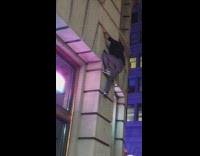 Guy climbs tall wall for photo