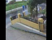 Black trash can moves down the street 