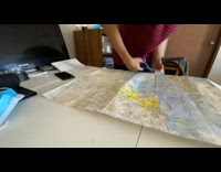 Time lapse of man tape laminate map