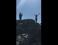 Woman pink tank top peace sign mountain top