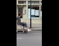Collab WINY - Man sit on chair on electric skateboard