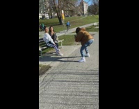 tow girls pose park bench